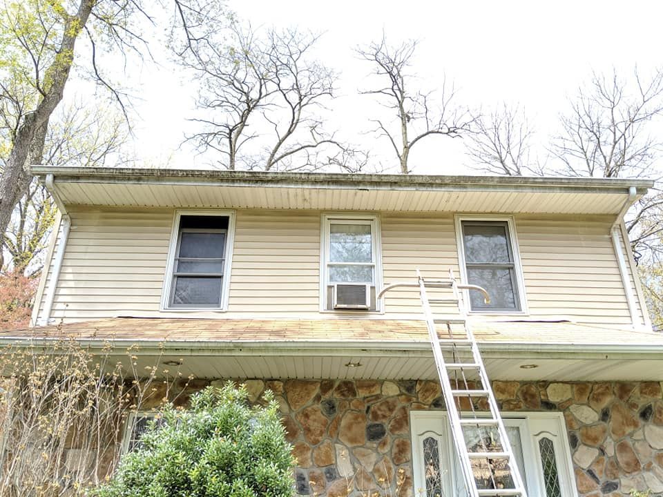 A house with a ladder on the side of it.