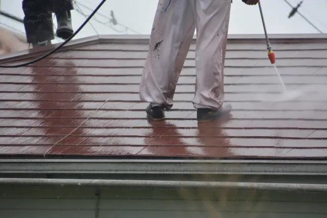 Professional roof cleaning and pressure washing service in action