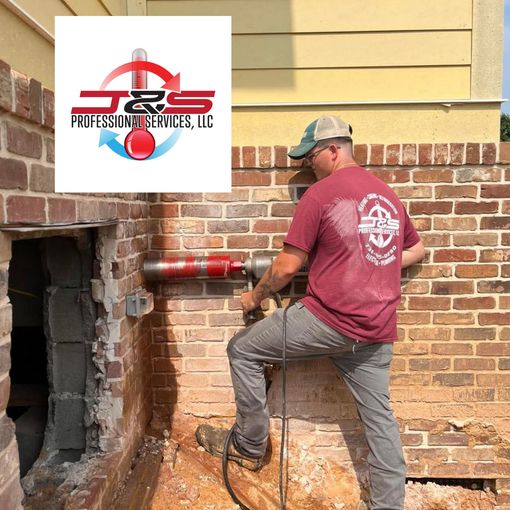 A man is working on a brick wall with a logo for j & s professional services llc