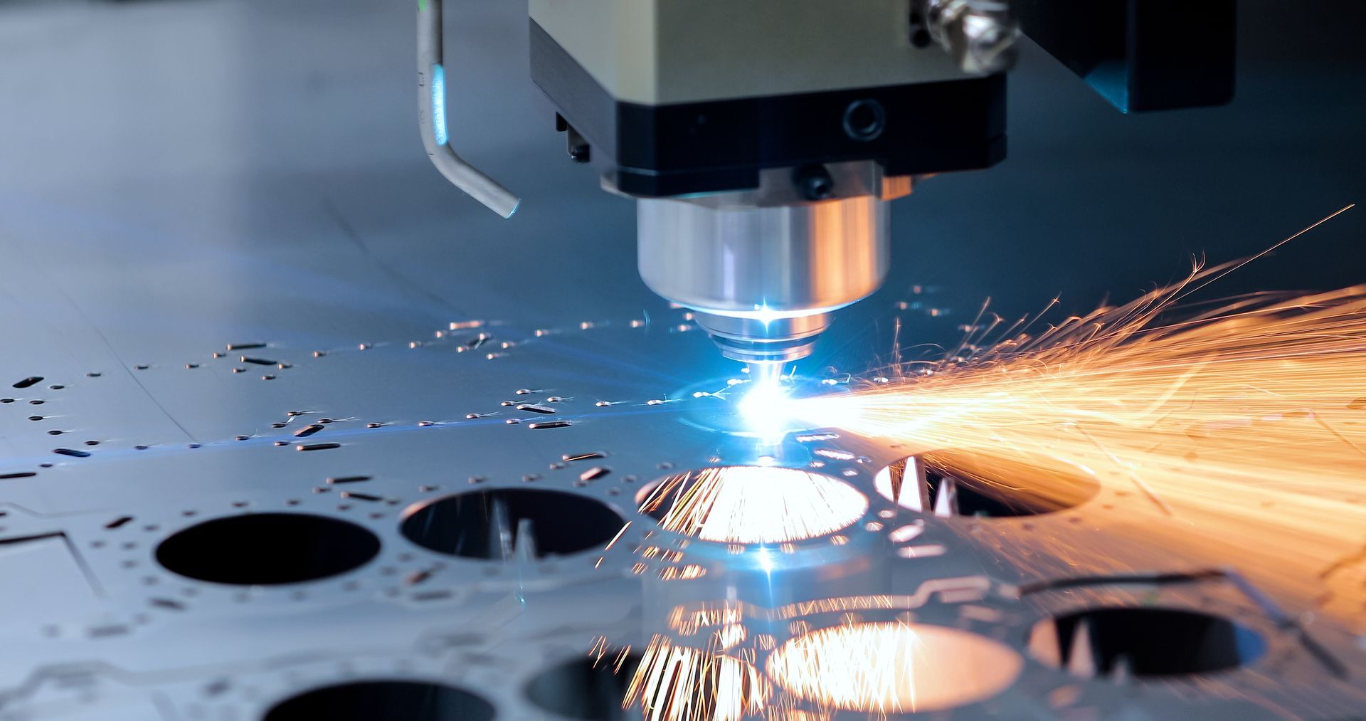 A machine is cutting a piece of metal with a laser.
