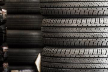 Stacked black tires with visible tread patterns.