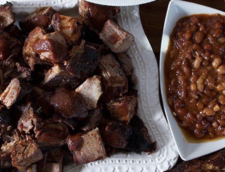 Smokehouse BBQ Kansas City plate of meat next to a bowl of beans