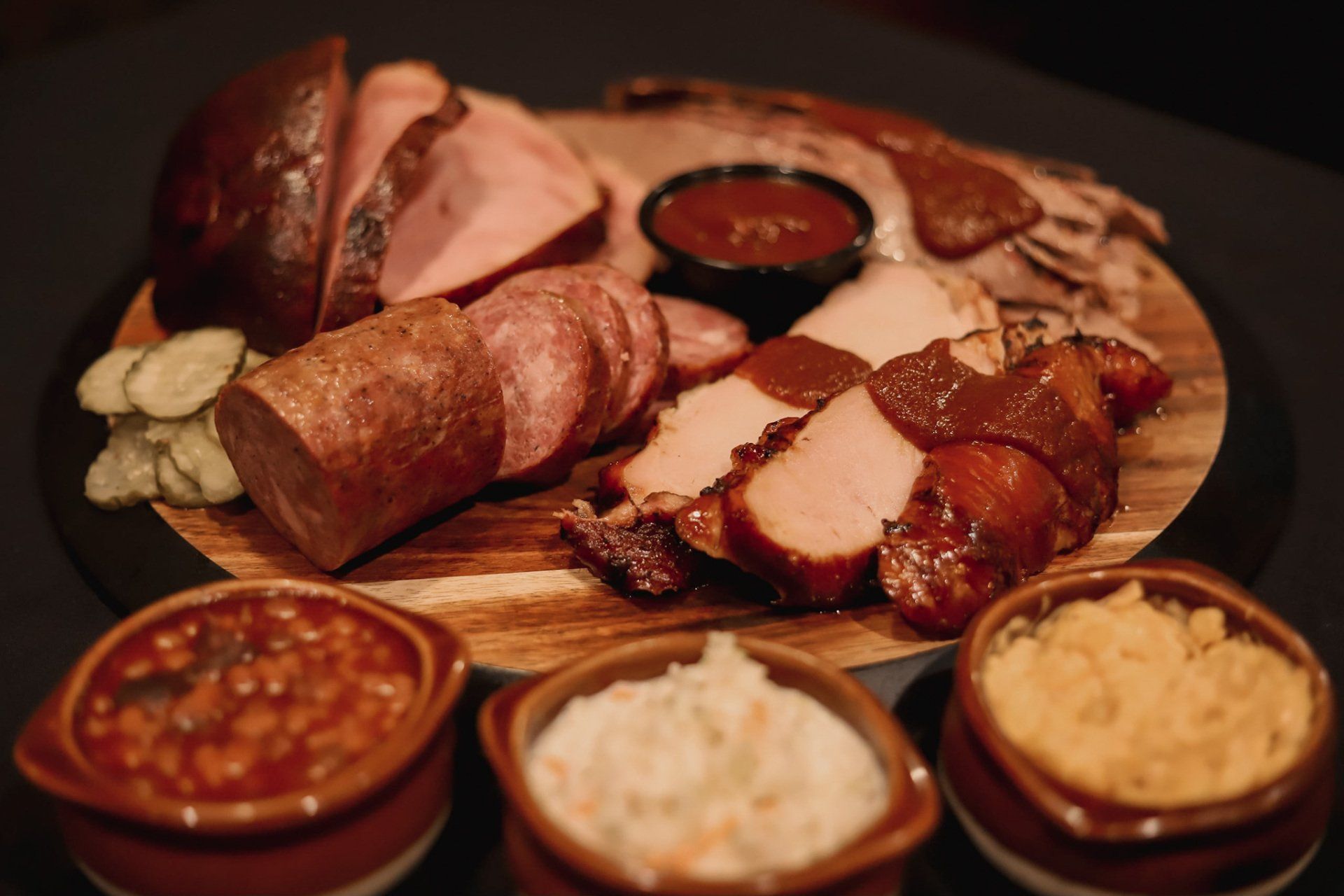 “Smokehouse barbecue meat platter with ribs, sausage, brisket, and sides at Kansas City BBQ restaurant