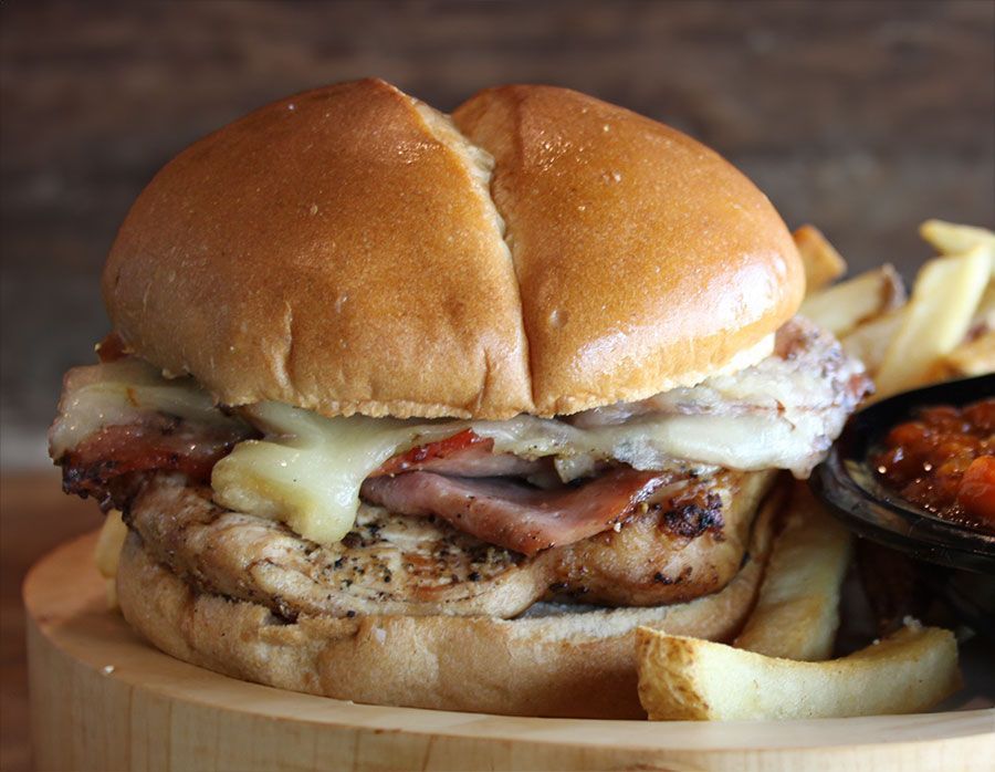 Chicken sandwich with french fries and a bowl of baked beans near Gladstone