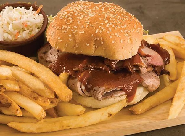 Pulled pork BBQ sandwich with fries and coleslaw near Kansas