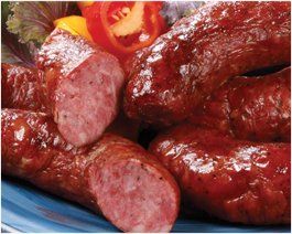 Bunch of sausages with lettuce and tomatoes in Kansas smokehouse bbq Menu