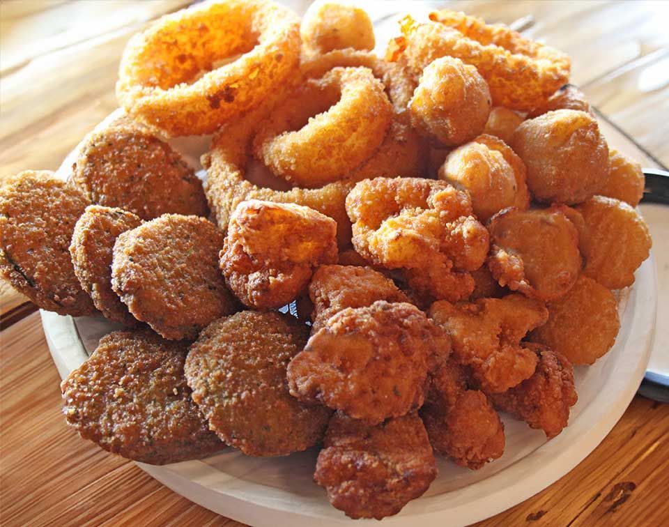 A plate of fried food including onion rings and chicken nuggets Kansas City smokehouse barbecue restaurant