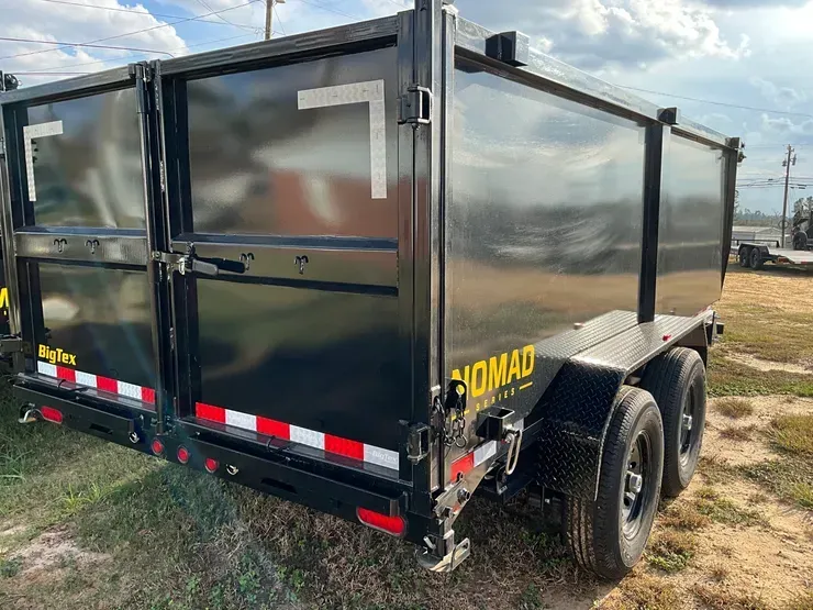 Woman in straw hat smiles, holding wine glass near a lake.