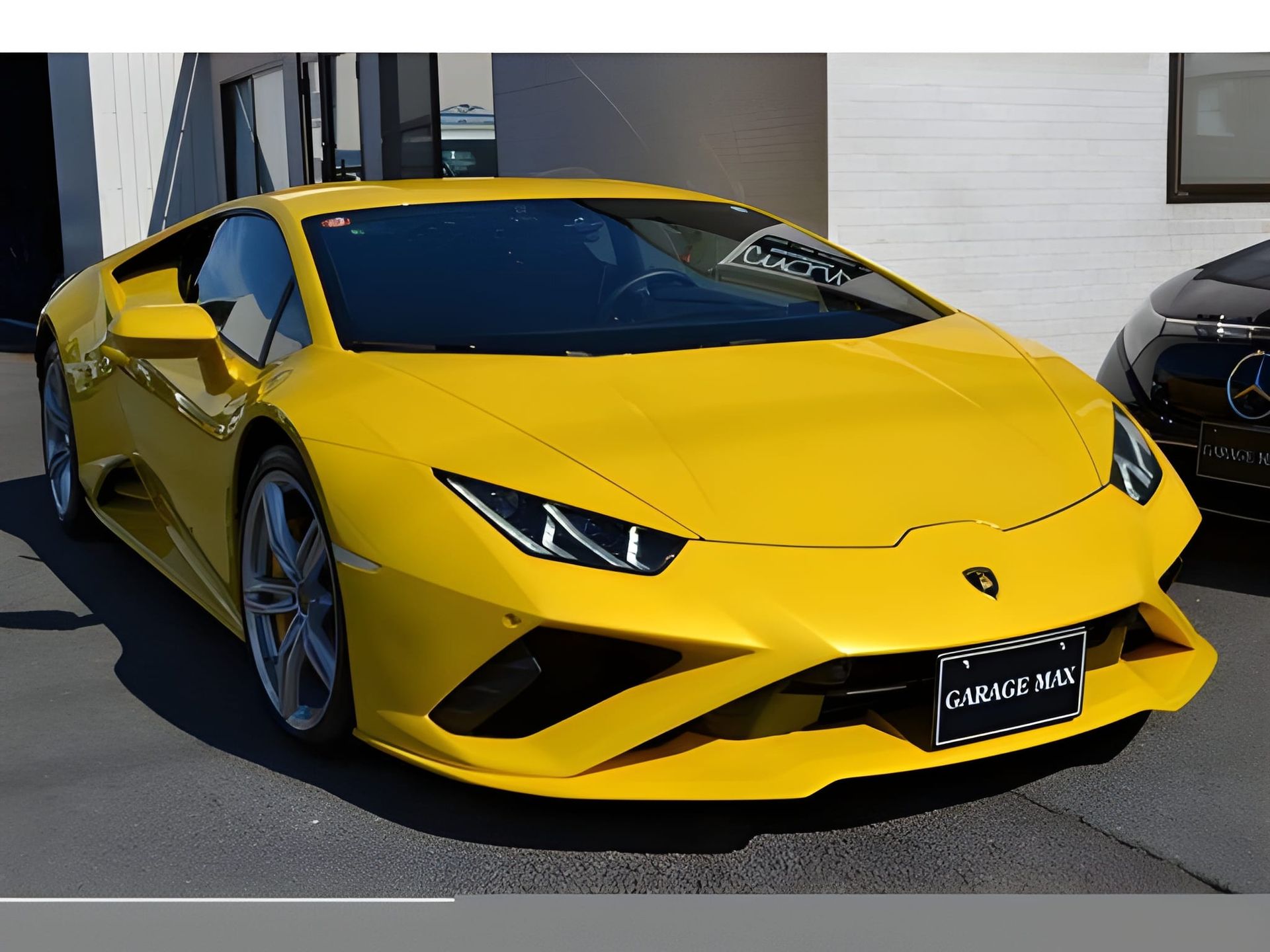 Yellow Lamborghini Huracan sports car parked in front of a building.