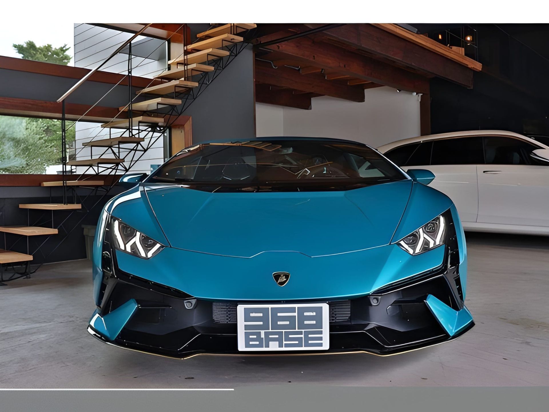 Blue Lamborghini sports car parked indoors, near a staircase and white car.