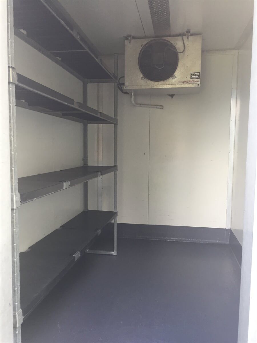 An Empty room with Shelves and a fan on the wall - Cool Room in Lindendale, NSW