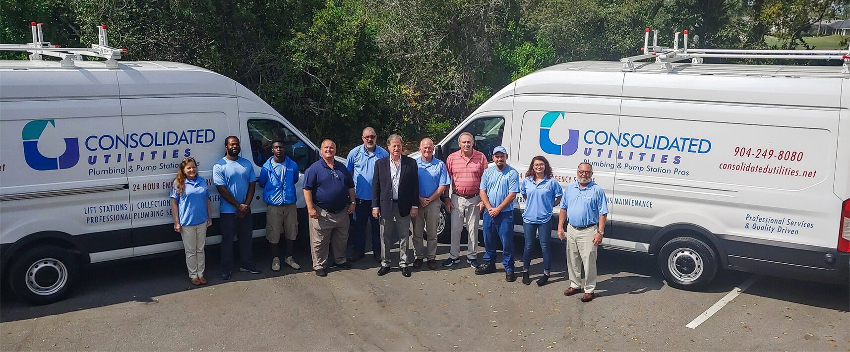 Two Company Vans & A Group Of Employees Two Company Vans & A Group Of Employees