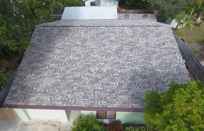 An aerial view of a house with a new roof.