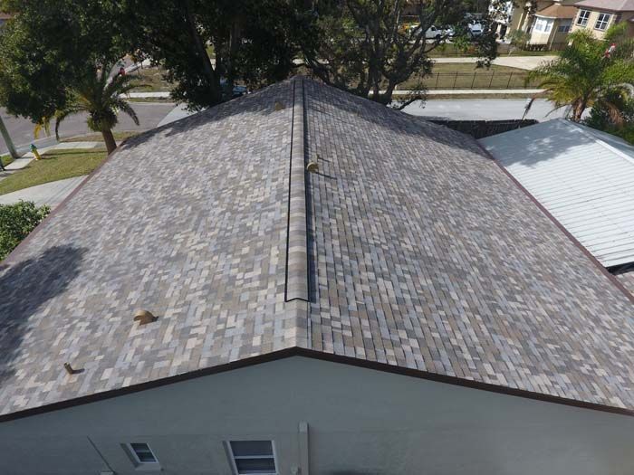 An aerial view of a house with a roof that has shingles on it.