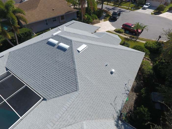 An aerial view of a house with a roof and a pool