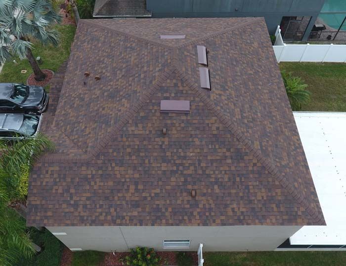 An aerial view of a house with a new roof.