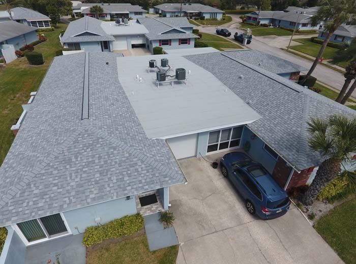 An aerial view of a house with a car parked in front of it.