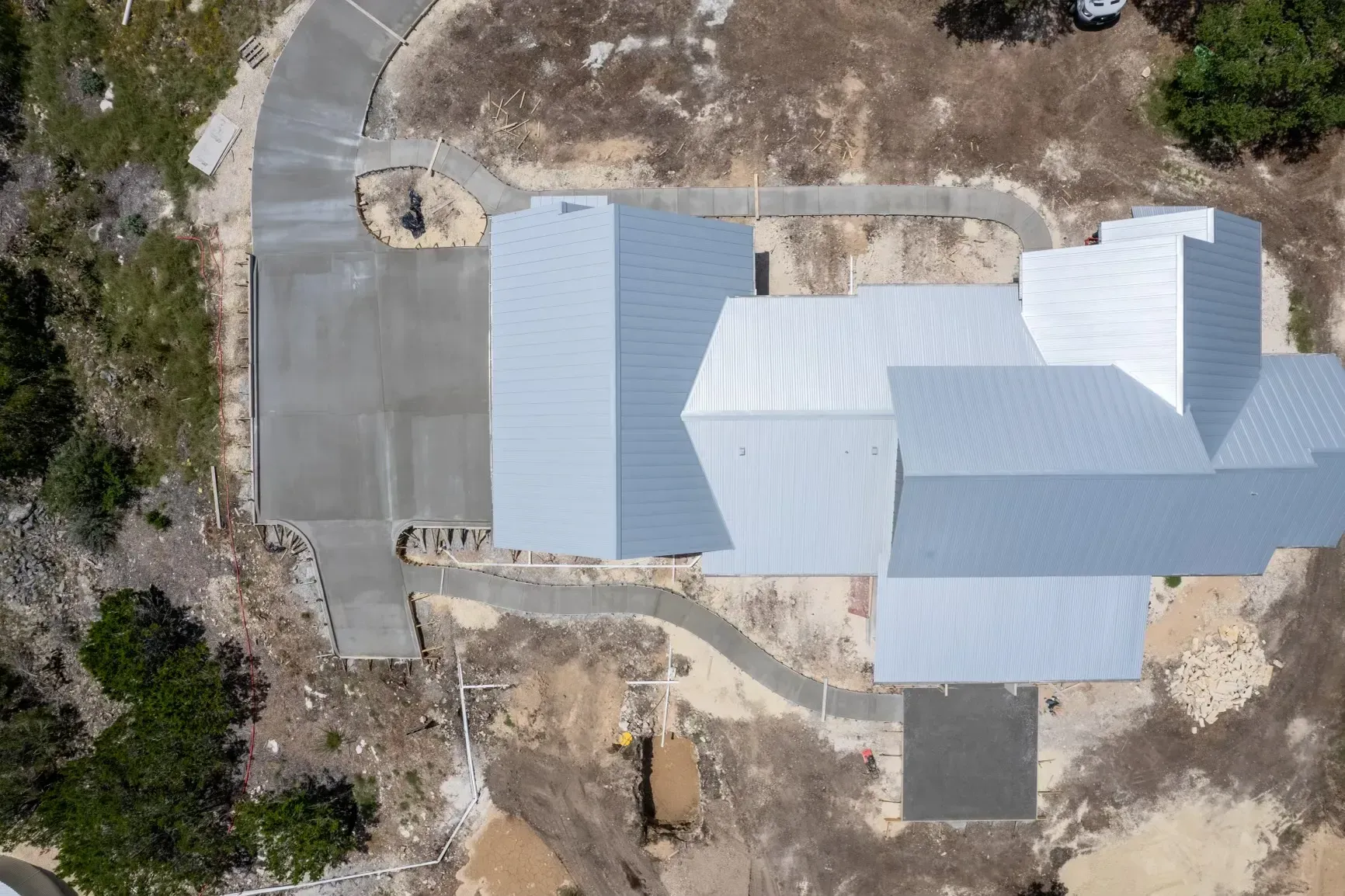 An aerial view of a house under construction in the middle of a field.
