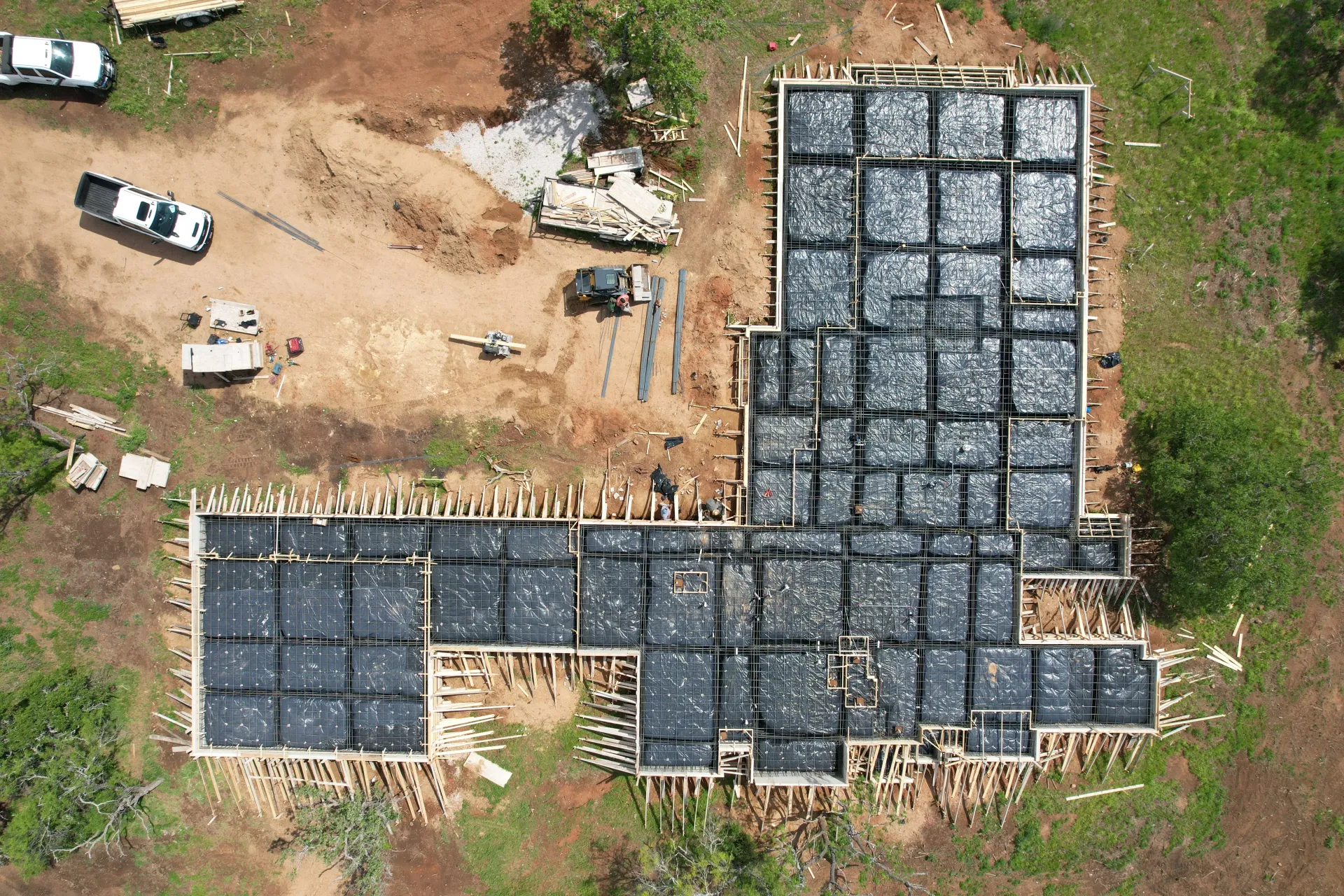 An aerial view of a building under construction in a field.