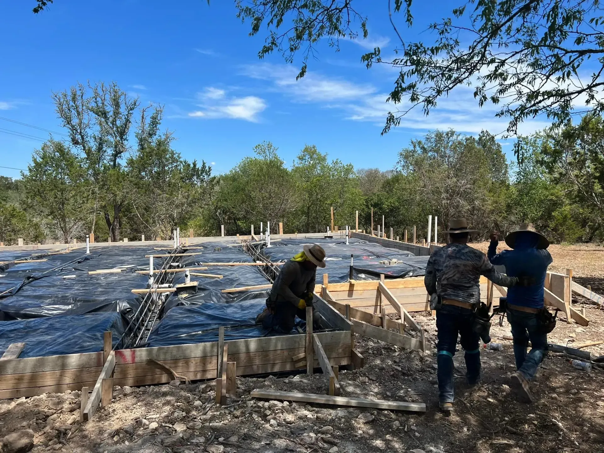 A group of construction workers are working on a construction site.