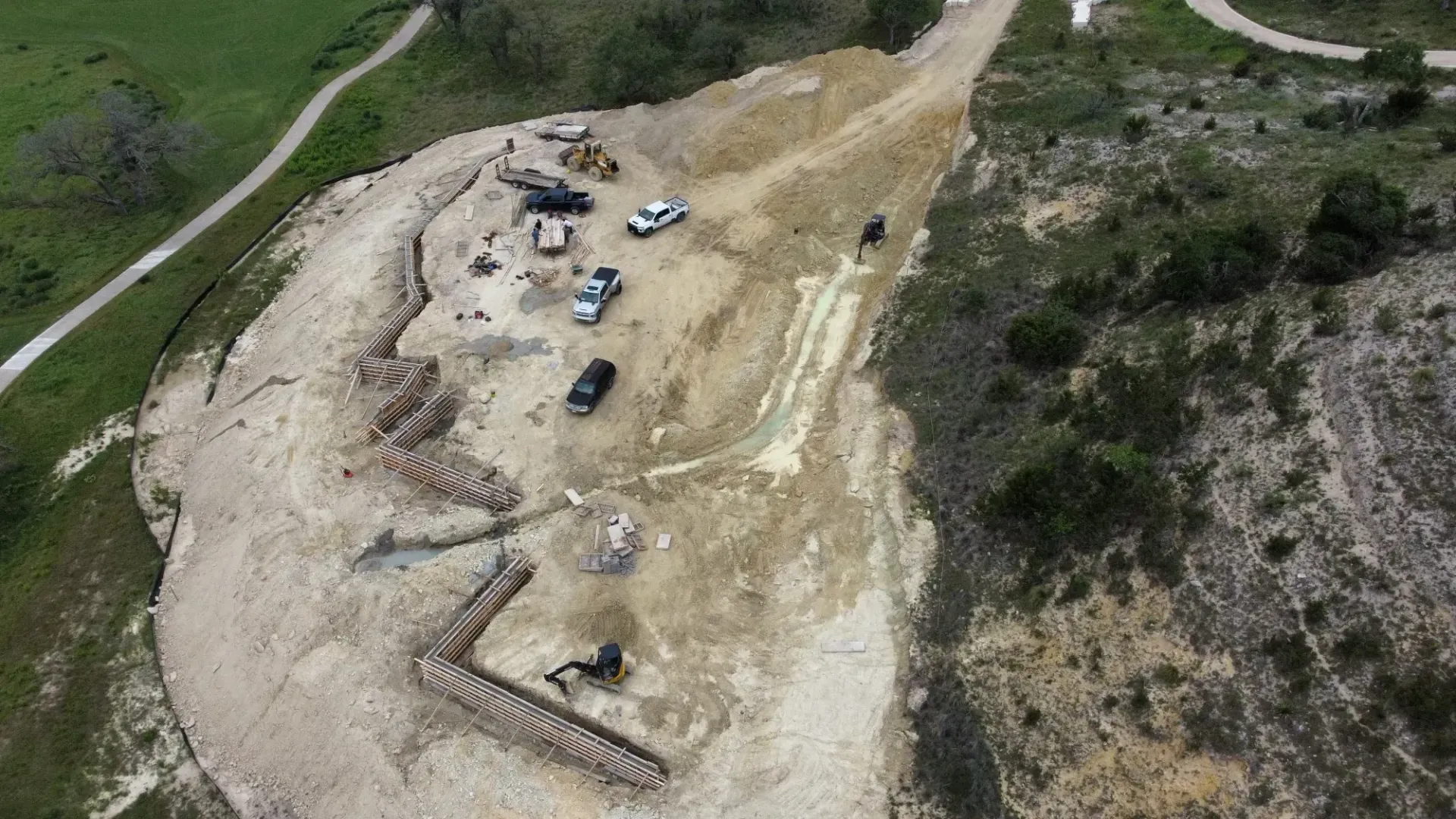 An aerial view of a construction site on a hillside.