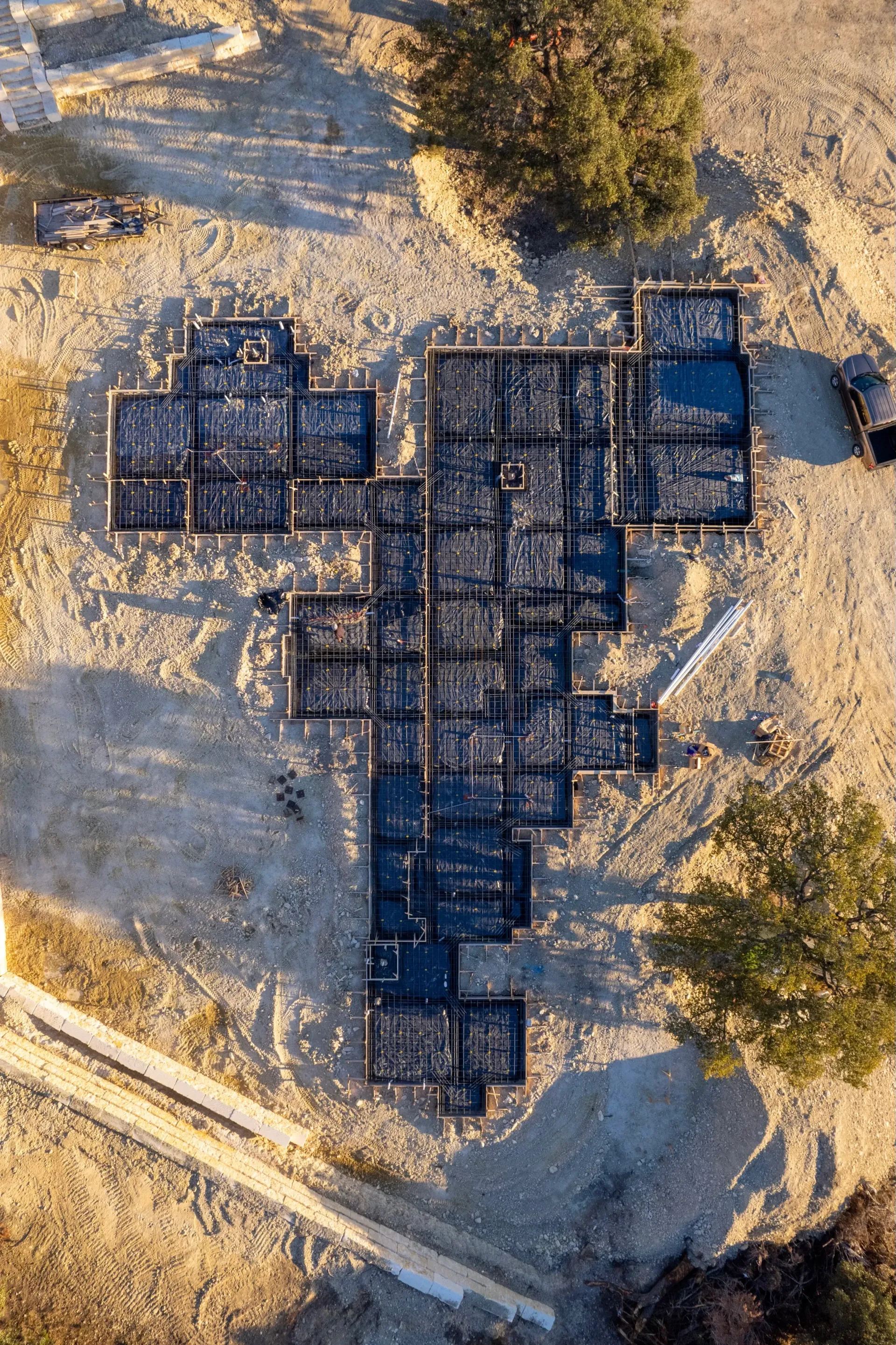 An aerial view of a building under construction in the shape of a heart.