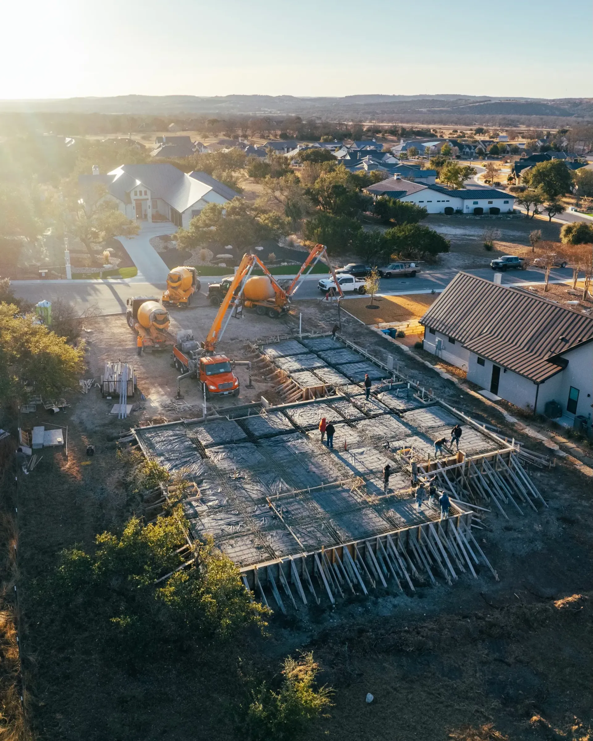 An aerial view of a building under construction in a residential area.