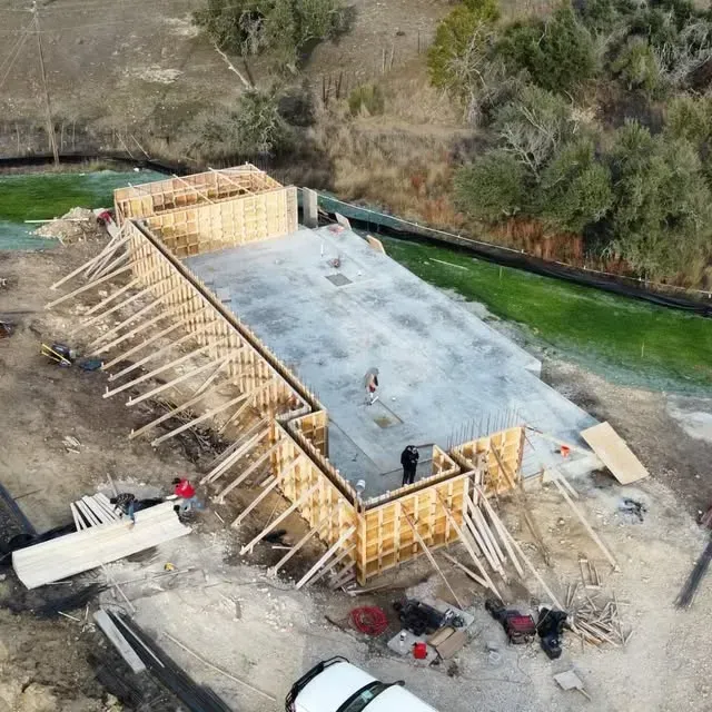 An aerial view of a building under construction next to a river.