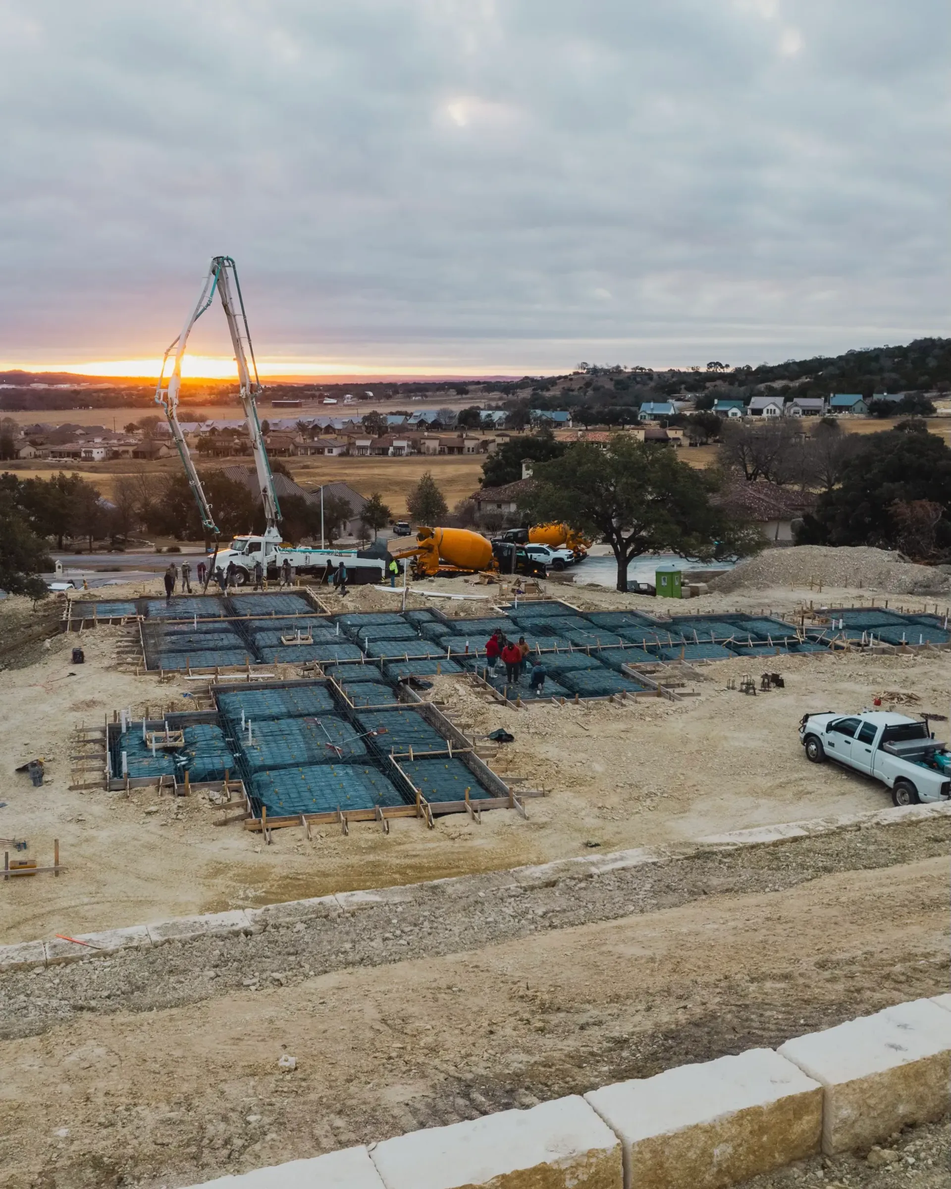 An aerial view of a construction site with a truck parked in the foreground.