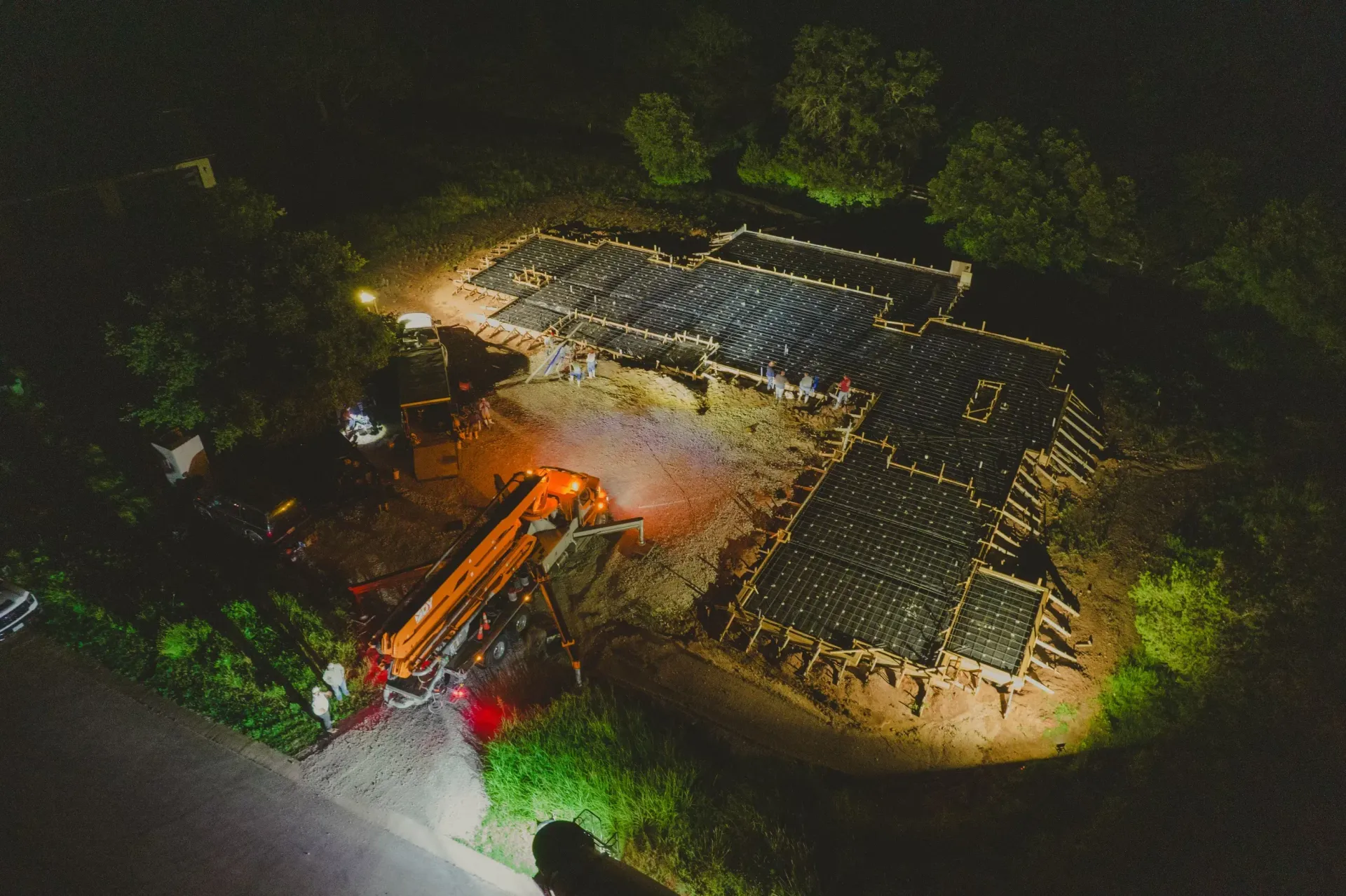 An aerial view of a house being built at night.
