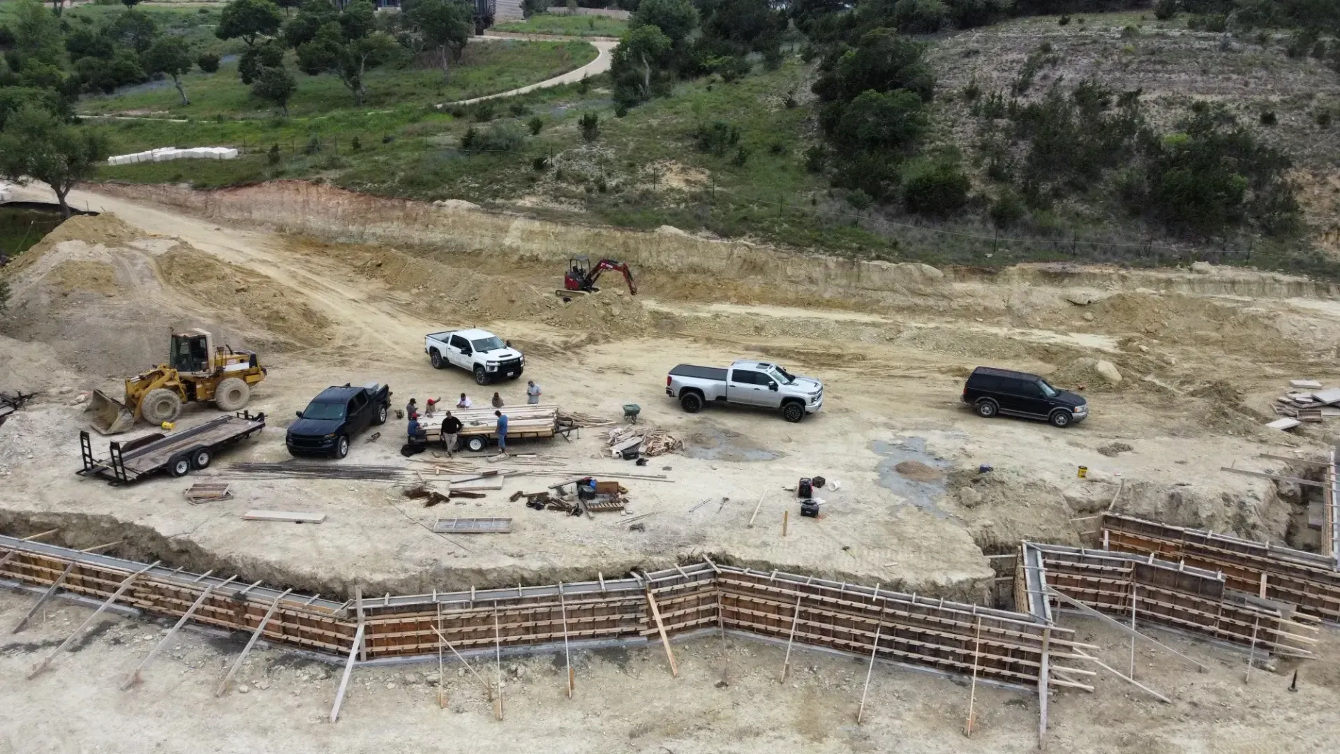 An aerial view of a construction site with trucks and tractors.