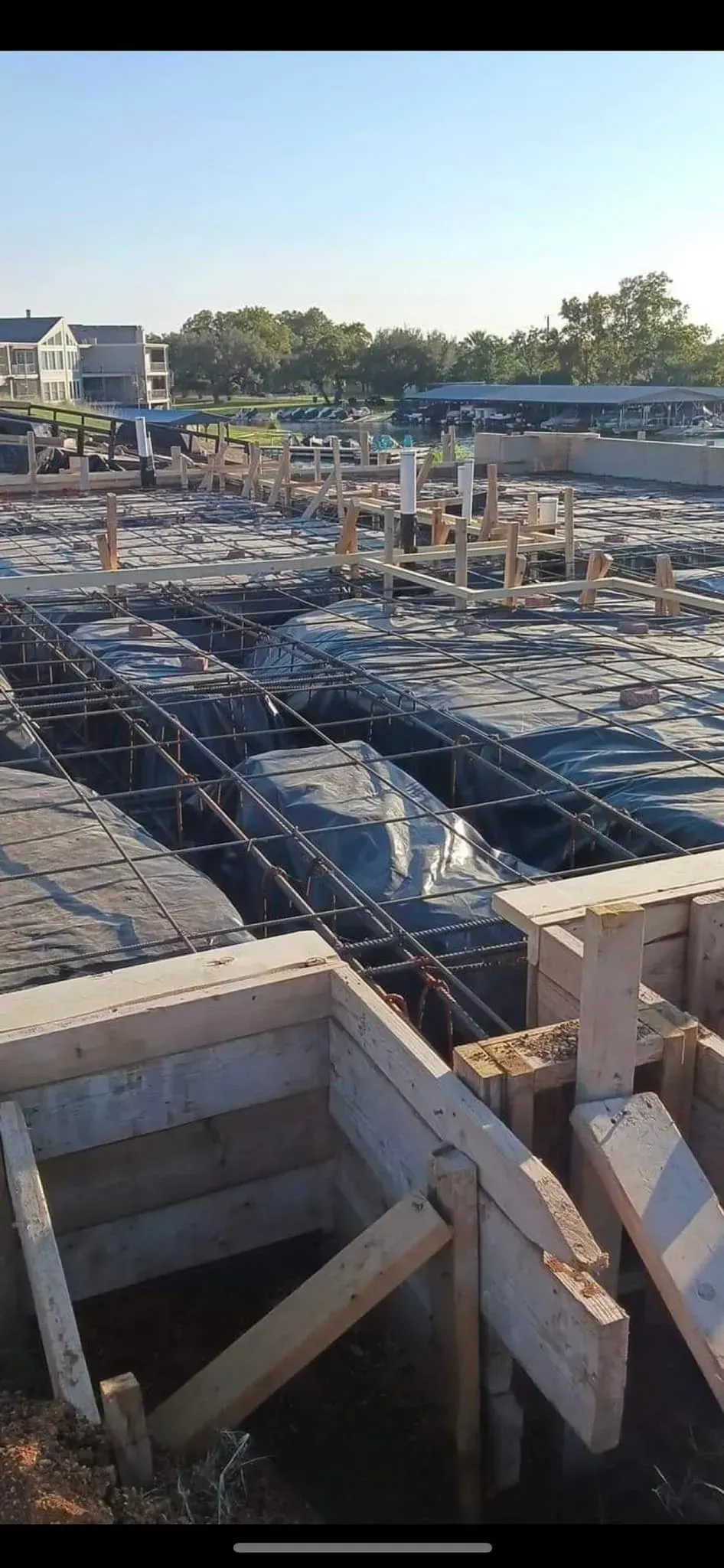 A construction site with a lot of concrete and wood.