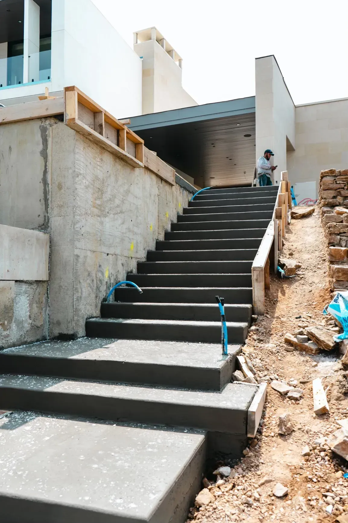 A set of concrete stairs leading up to a building under construction.