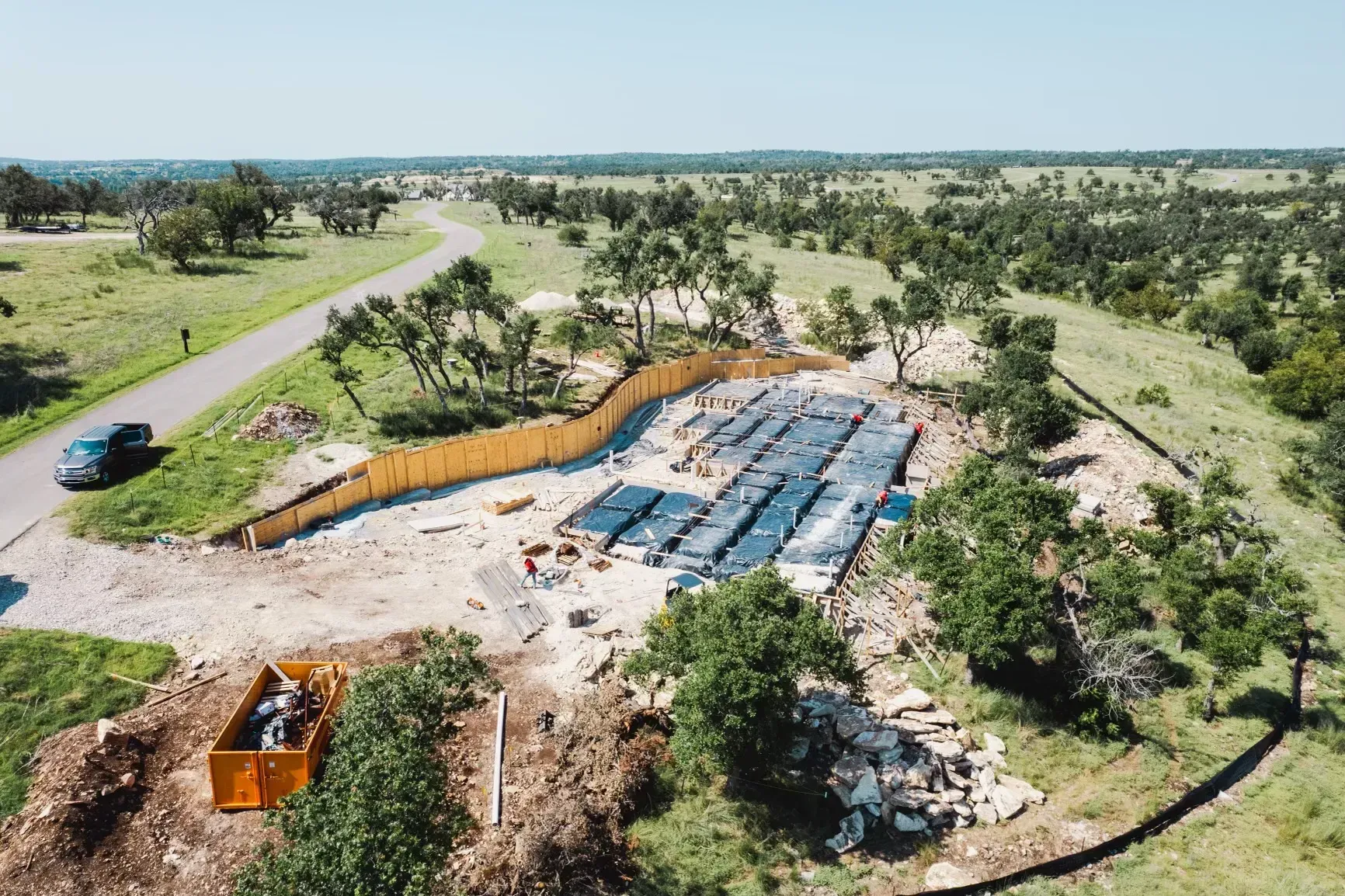 An aerial view of a construction site in the middle of a field.