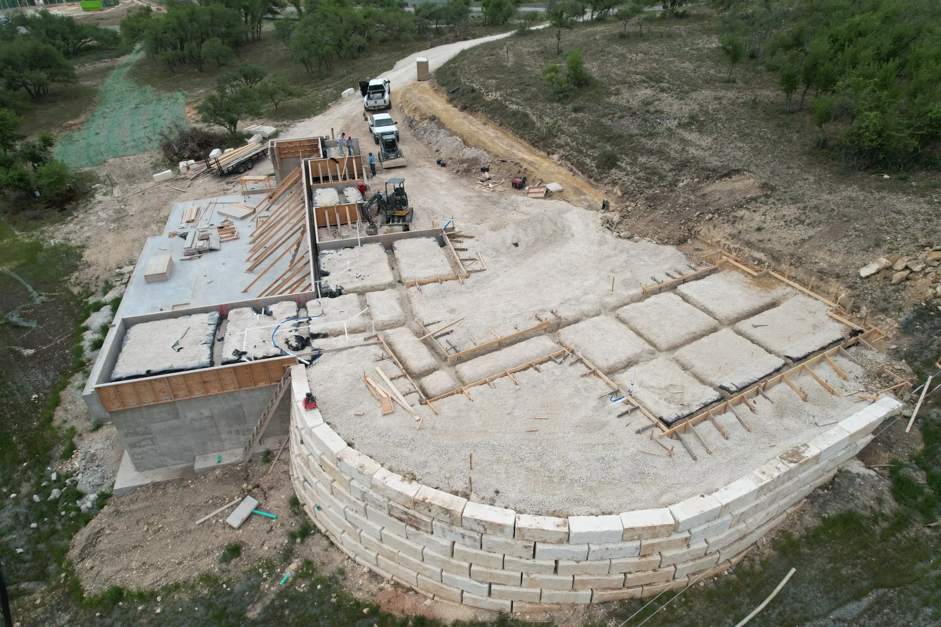 An aerial view of a building under construction in the middle of a field.