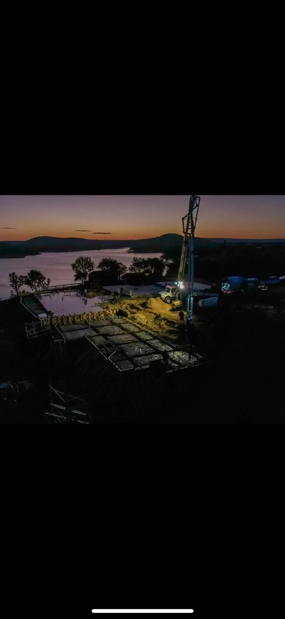 A painting of a sunset over a body of water.