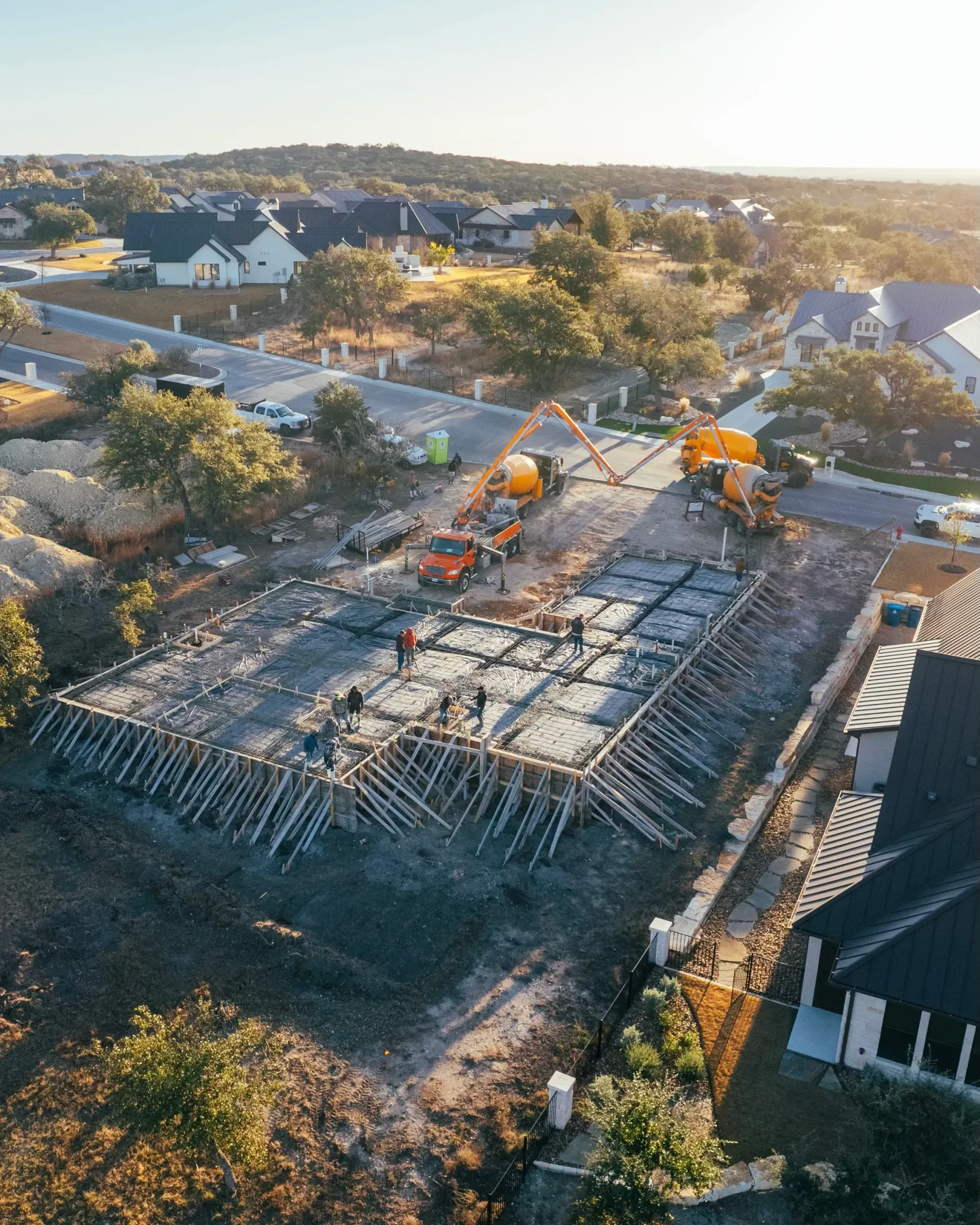 An aerial view of a house under construction in a residential area.
