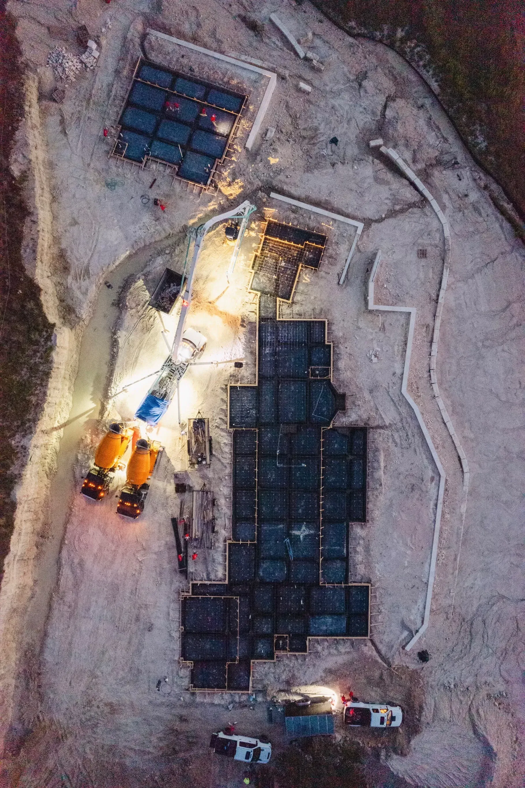 An aerial view of a construction site at night.