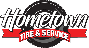 Logo for Hometown Tire & Service with stylized white text over a black tire graphic and a red banner.