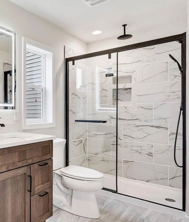 Woman in straw hat smiles, holding wine glass near a lake.
