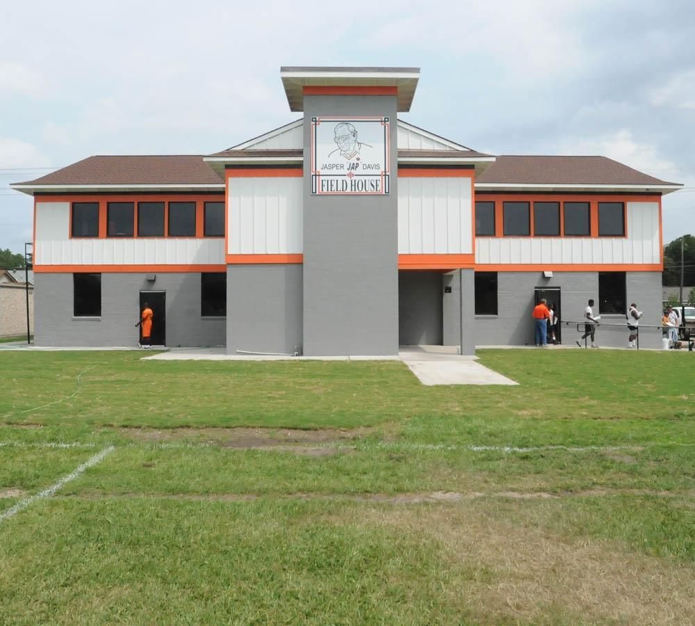 A gray and orange building with a sign that says