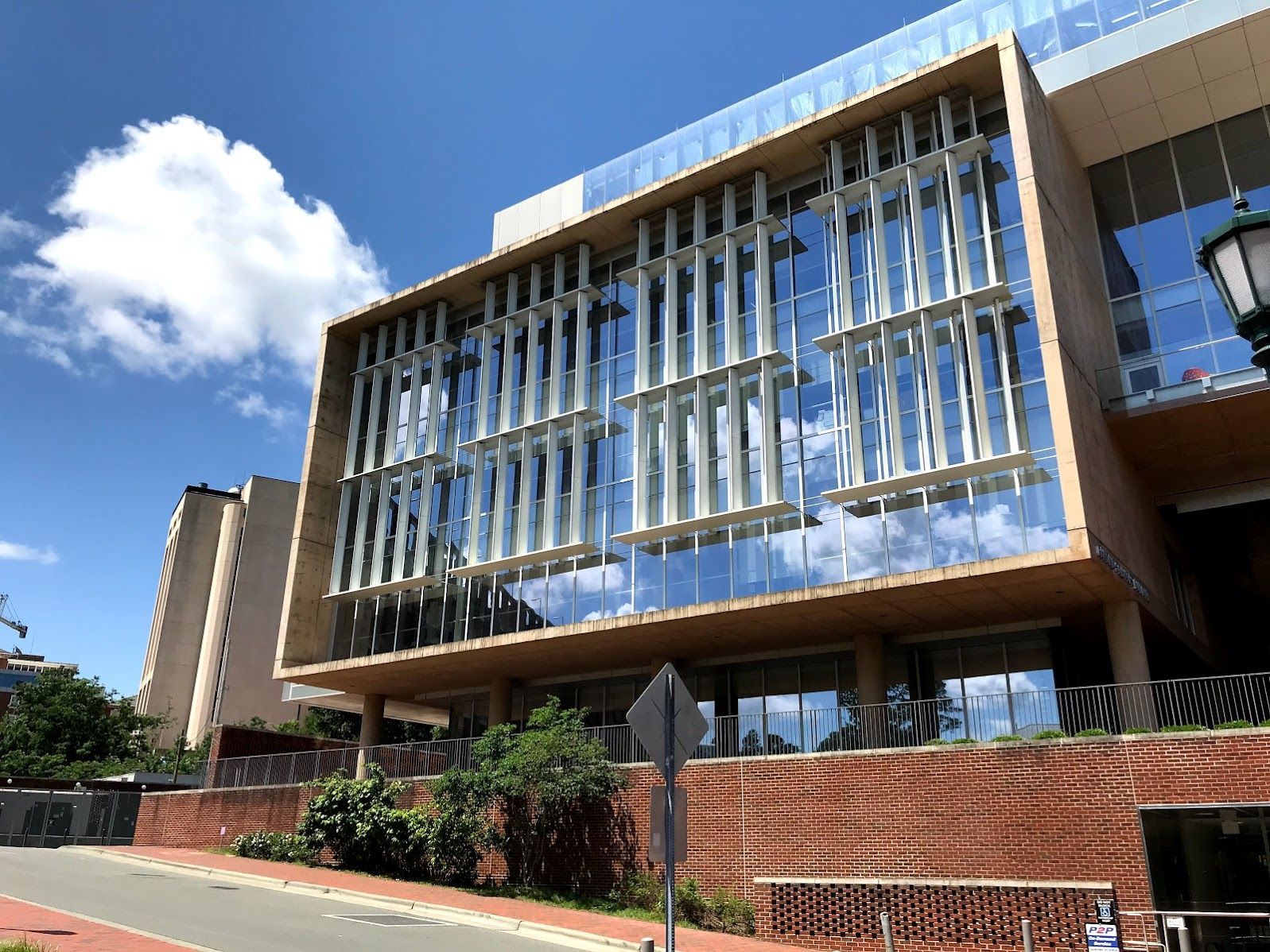 A large building with a lot of windows on a sunny day.