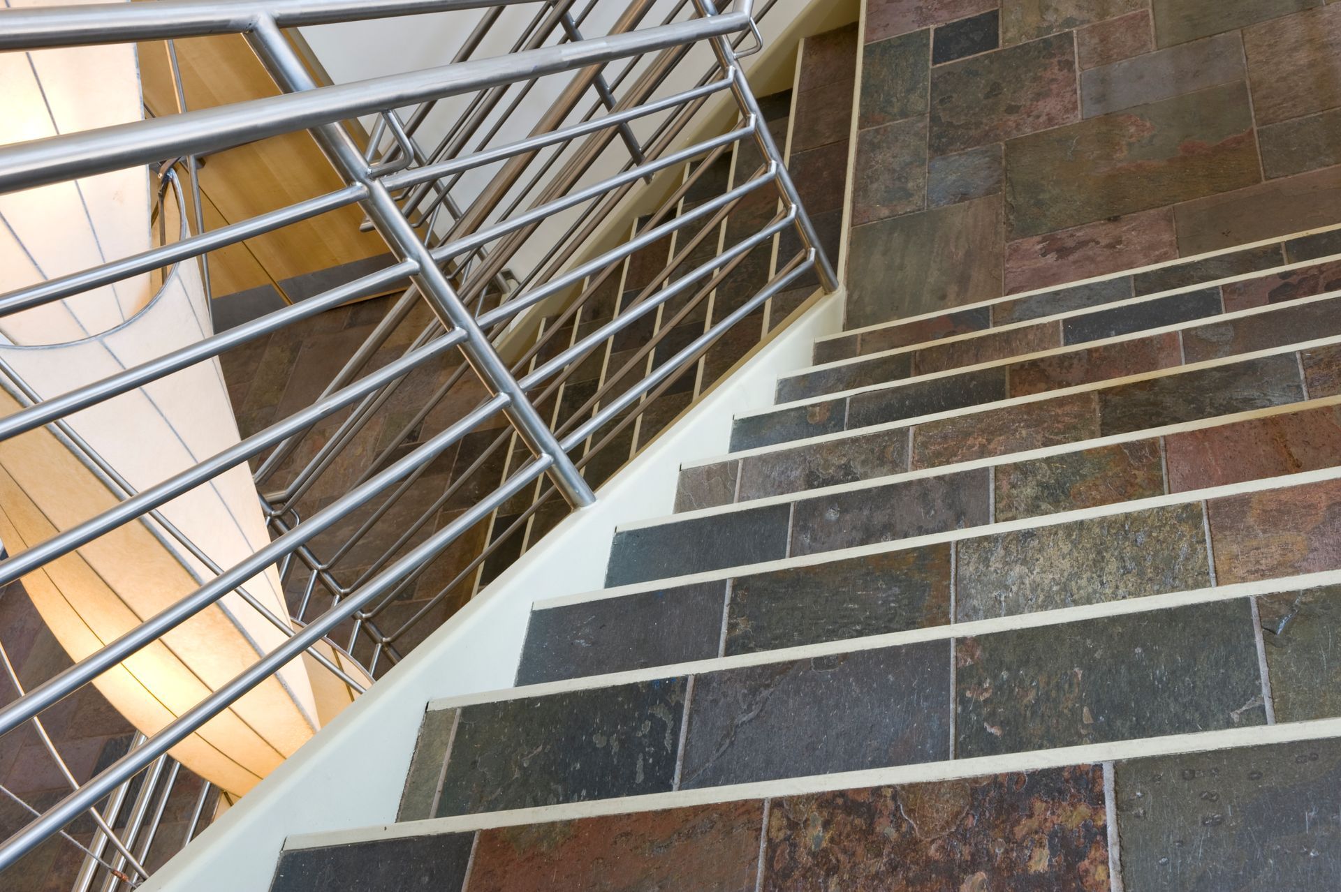 A set of stairs with a stainless steel railing