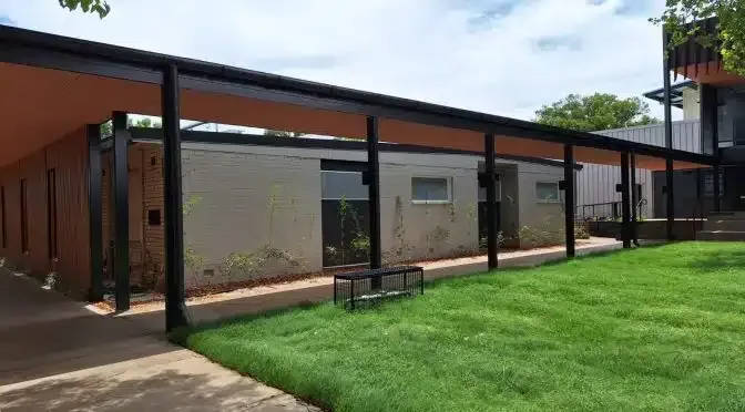 A Building With a Covered Walkway and a Lush Green Lawn in Front of It — Siash Construction Group in Elliot Heads, QLD