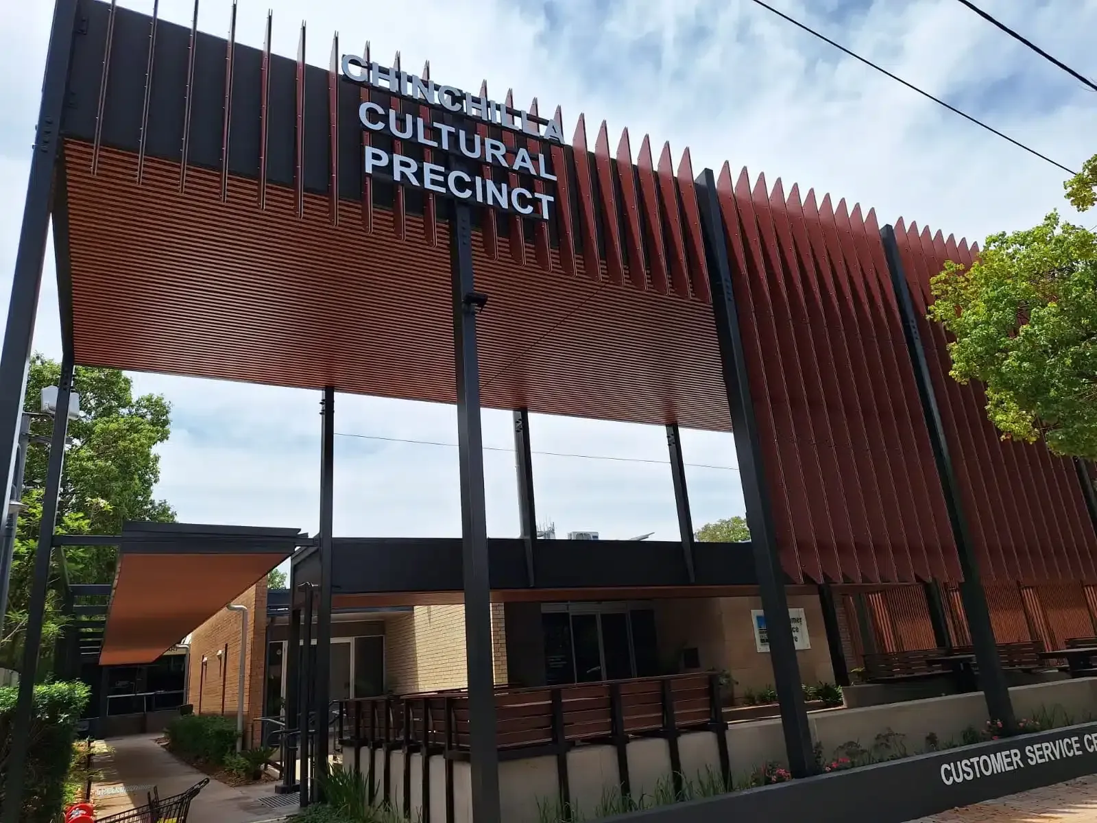 A Modern White House With a Wooden Garage Door — Siash Construction Group in Gooburrum, QLD