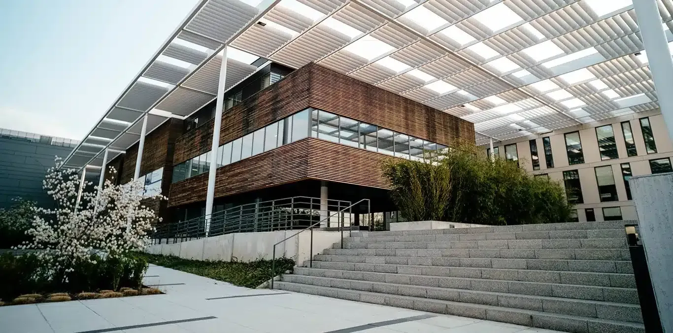 A Large Building With Stairs Leading Up to It and a Canopy Over It — Siash Construction Group in Bargara, QLD