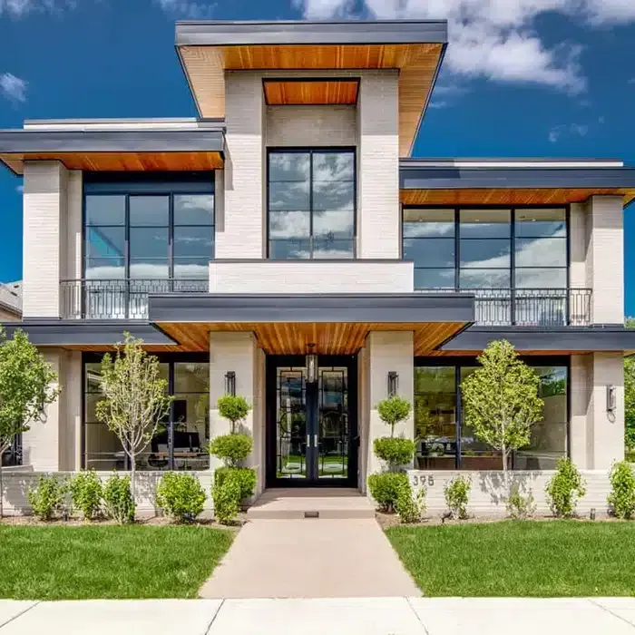 A Large House With a Lot of Windows and Trees in Front of It — Siash Construction Group in Elliot Heads, QLD