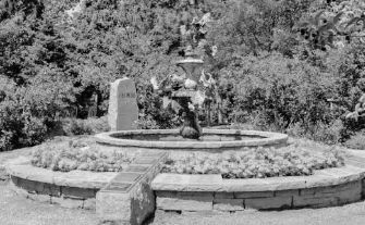 Peaceful memorial garden with fountain and stone markers, offering a serene place for families to remember and honor a loved one.