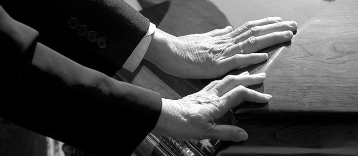 Open calendar with a pencil and flowers, symbolizing the planning involved in funeral arrangements.