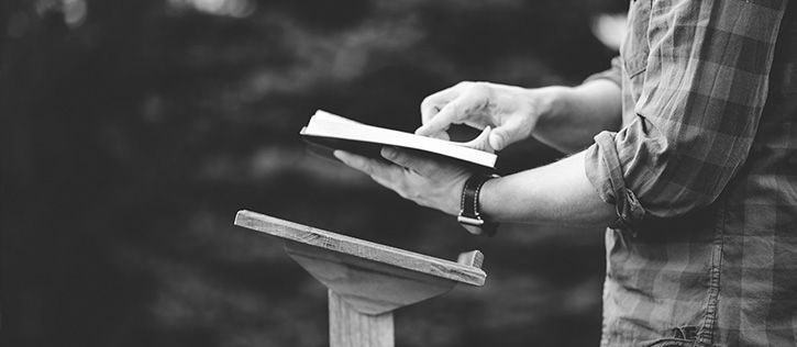 Friends sharing stories and laughter over drinks at a funeral gathering, reflecting the supportive, personal atmosphere often found at a non-religious celebration of life.